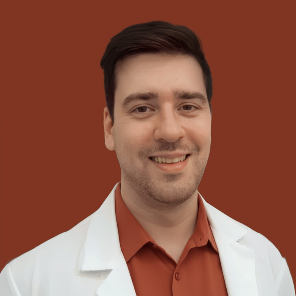 Dr. Rami Khaldieh, smiling optometrist wearing a white coat, against a warm brown background.